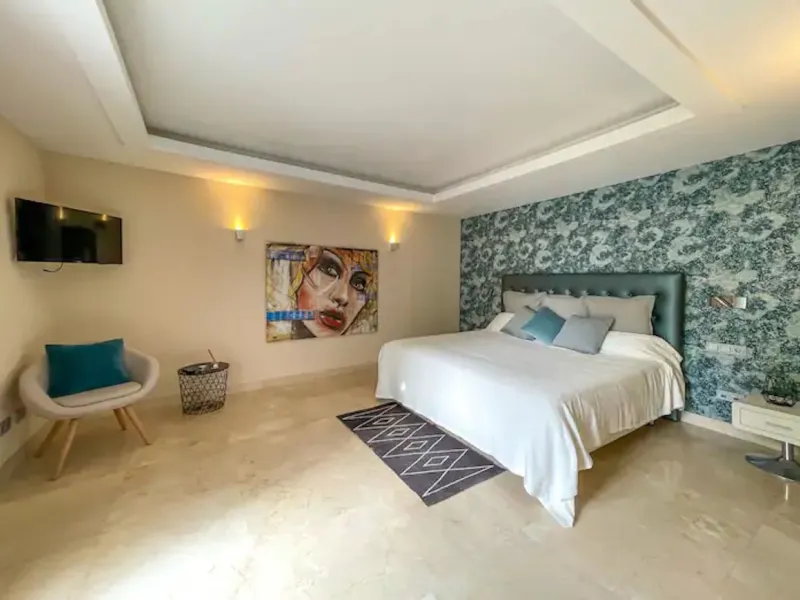 This magnificent villa is an open plan one, and the ground floor flows into the terrace and the garden with lovely sea views and a vast infinity pool, leading to a chill-out area with a fireplace. The villa has ensuite bedrooms on each floor, which gives 