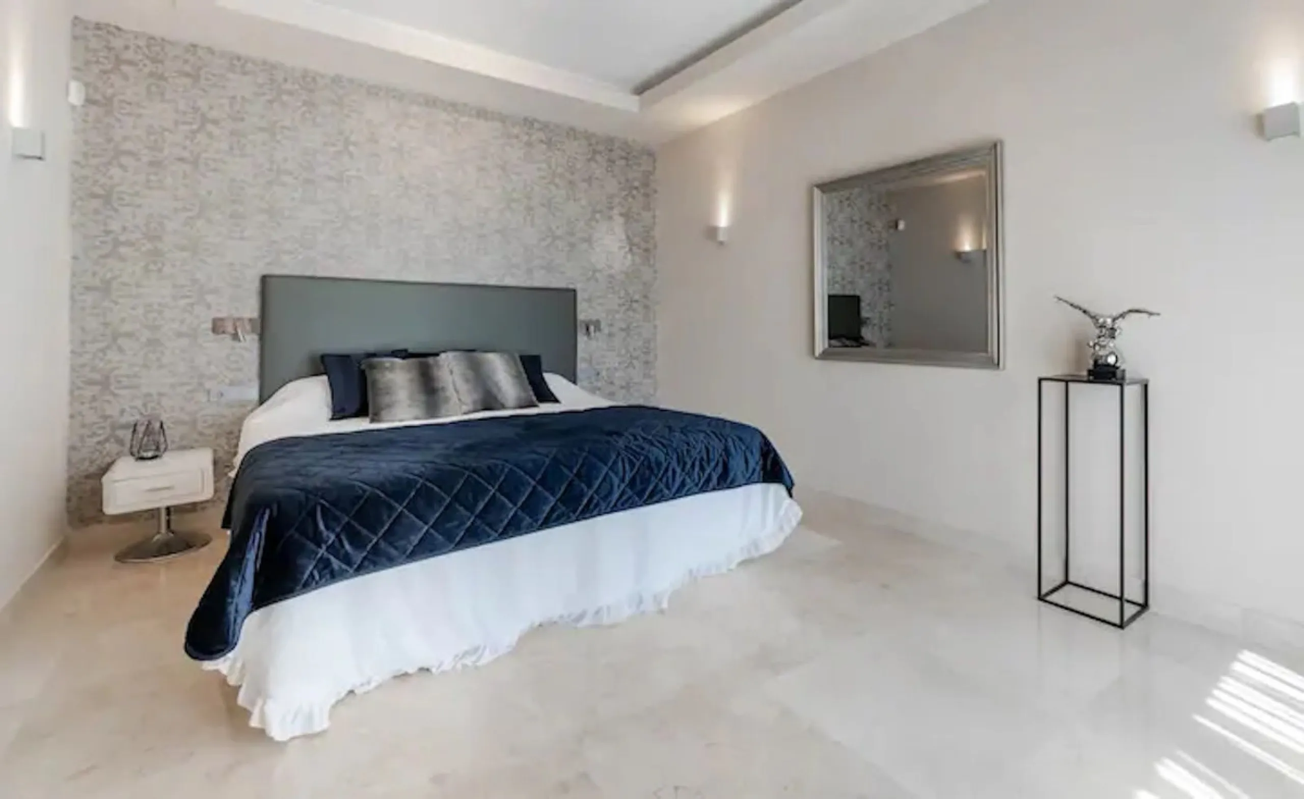 This magnificent villa is an open plan one, and the ground floor flows into the terrace and the garden with lovely sea views and a vast infinity pool, leading to a chill-out area with a fireplace. The villa has ensuite bedrooms on each floor, which gives 