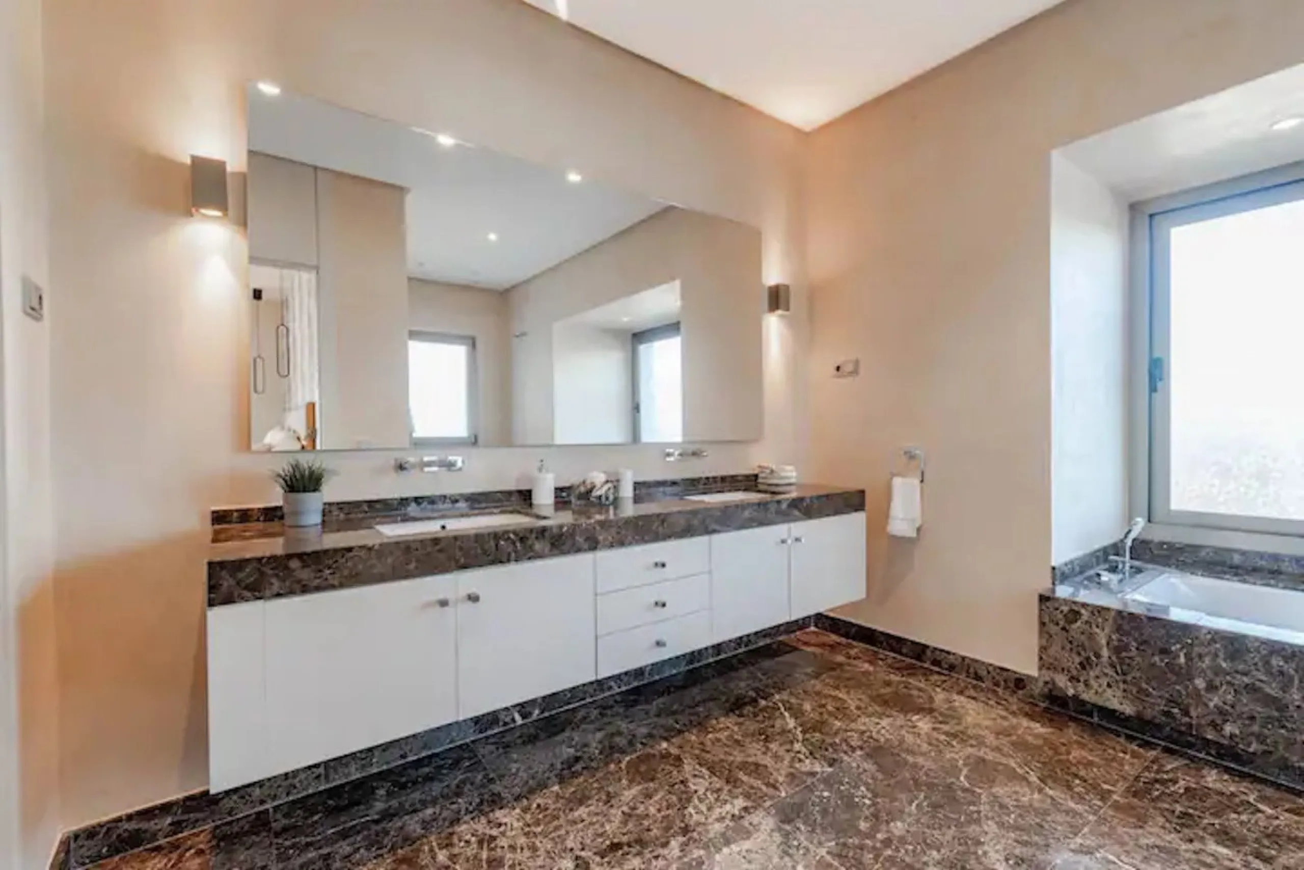 This magnificent villa is an open plan one, and the ground floor flows into the terrace and the garden with lovely sea views and a vast infinity pool, leading to a chill-out area with a fireplace. The villa has ensuite bedrooms on each floor, which gives 