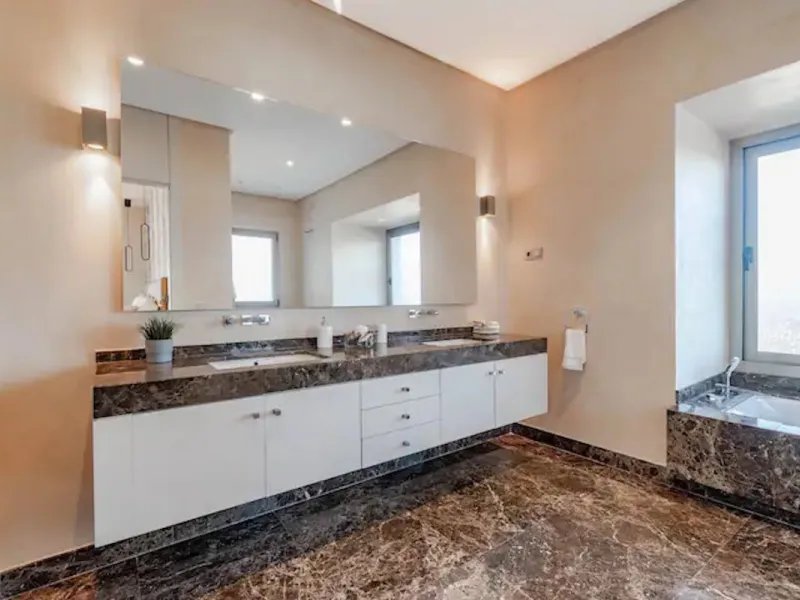 This magnificent villa is an open plan one, and the ground floor flows into the terrace and the garden with lovely sea views and a vast infinity pool, leading to a chill-out area with a fireplace. The villa has ensuite bedrooms on each floor, which gives 