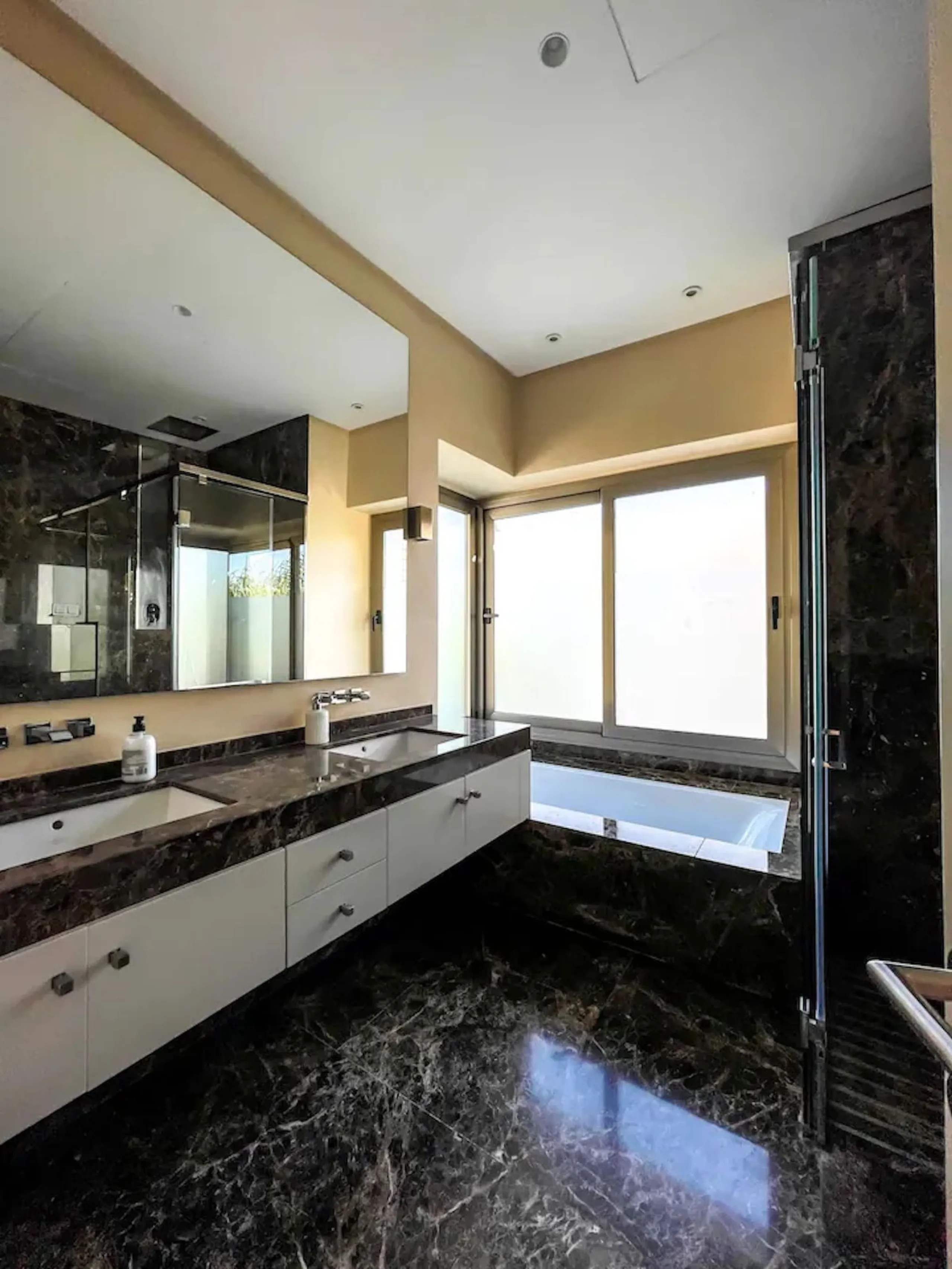 This magnificent villa is an open plan one, and the ground floor flows into the terrace and the garden with lovely sea views and a vast infinity pool, leading to a chill-out area with a fireplace. The villa has ensuite bedrooms on each floor, which gives 