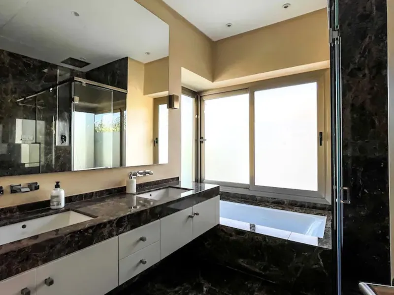 This magnificent villa is an open plan one, and the ground floor flows into the terrace and the garden with lovely sea views and a vast infinity pool, leading to a chill-out area with a fireplace. The villa has ensuite bedrooms on each floor, which gives 