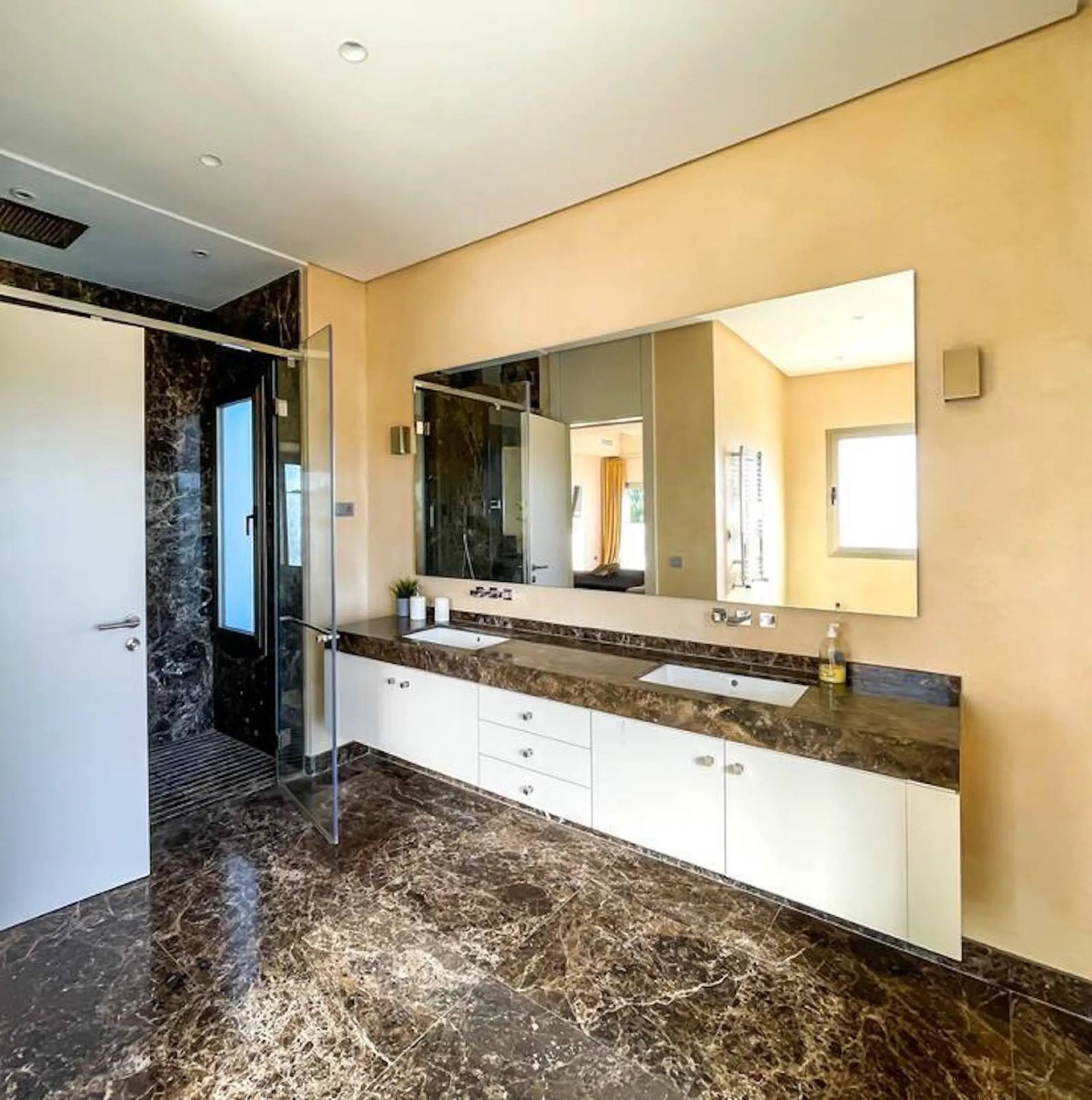 This magnificent villa is an open plan one, and the ground floor flows into the terrace and the garden with lovely sea views and a vast infinity pool, leading to a chill-out area with a fireplace. The villa has ensuite bedrooms on each floor, which gives 