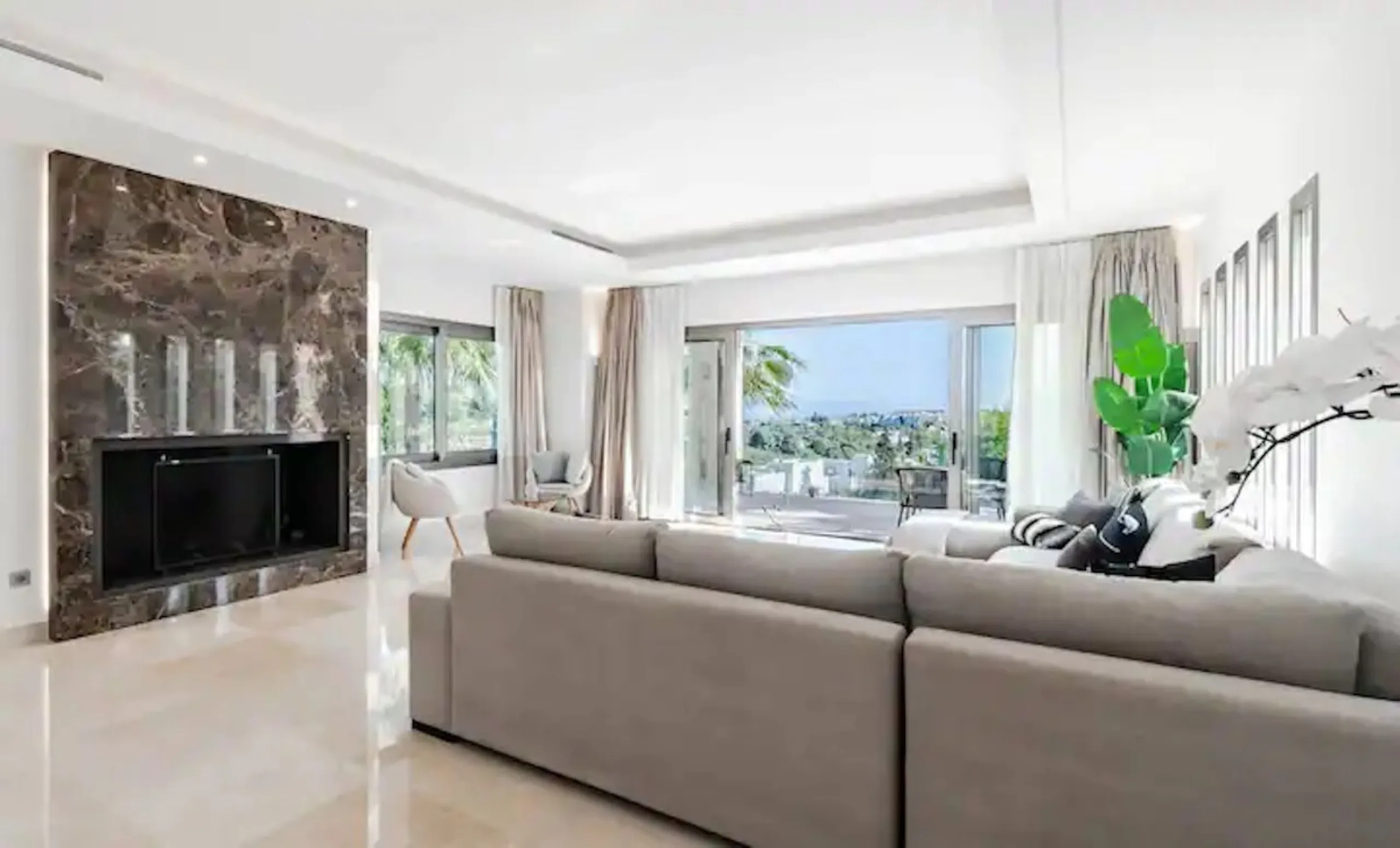 This magnificent villa is an open plan one, and the ground floor flows into the terrace and the garden with lovely sea views and a vast infinity pool, leading to a chill-out area with a fireplace. The villa has ensuite bedrooms on each floor, which gives 