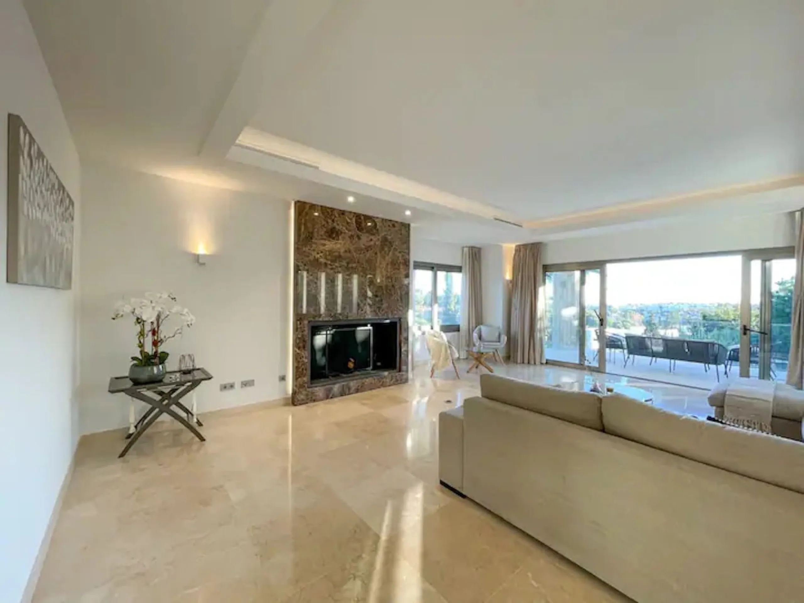 This magnificent villa is an open plan one, and the ground floor flows into the terrace and the garden with lovely sea views and a vast infinity pool, leading to a chill-out area with a fireplace. The villa has ensuite bedrooms on each floor, which gives 