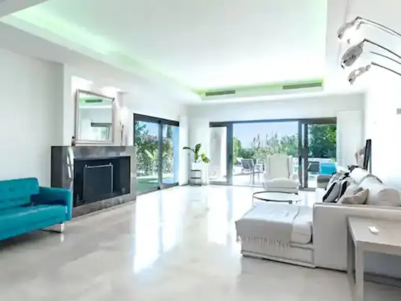 This magnificent villa is an open plan one, and the ground floor flows into the terrace and the garden with lovely sea views and a vast infinity pool, leading to a chill-out area with a fireplace. The villa has ensuite bedrooms on each floor, which gives 