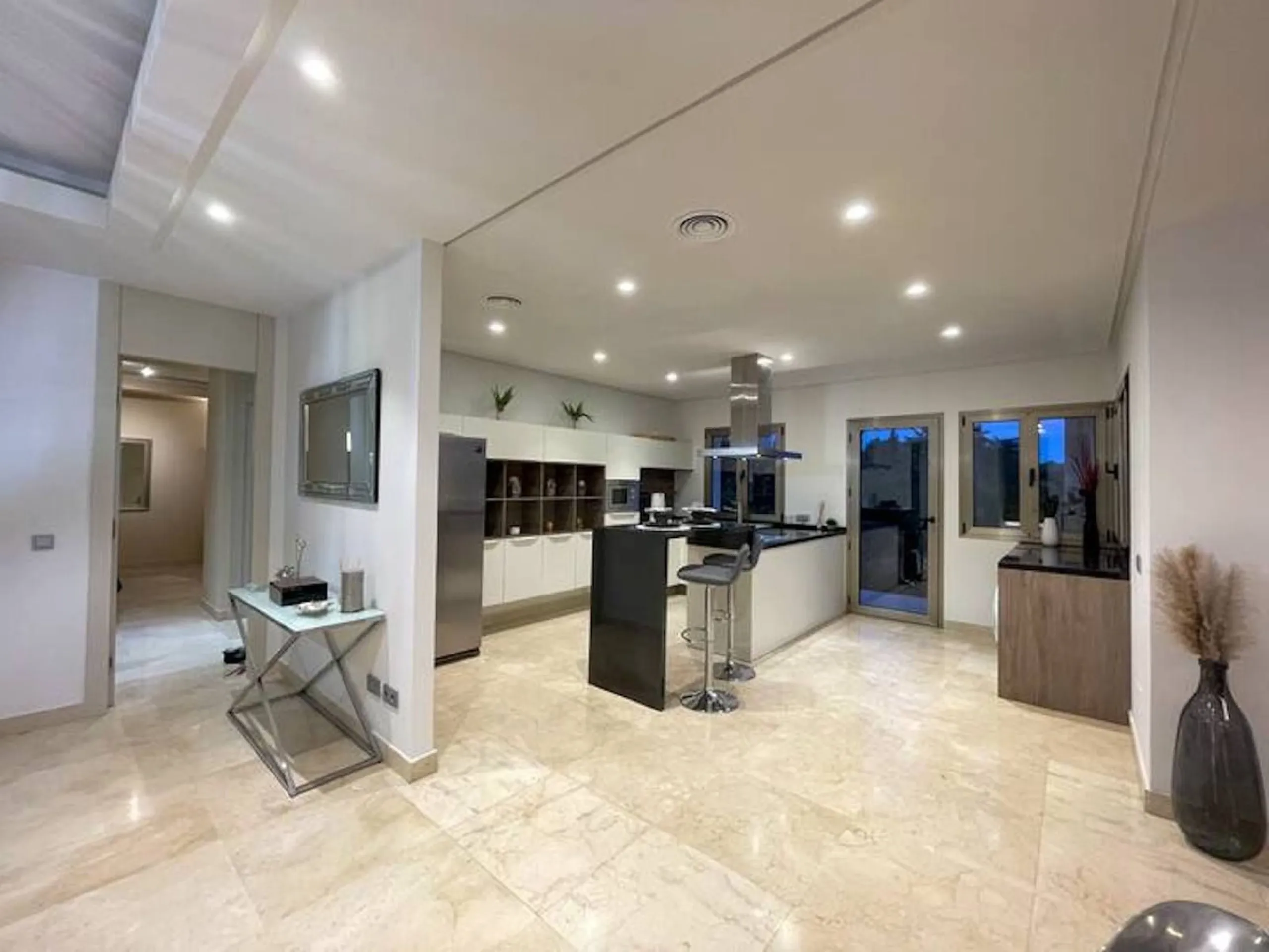 This magnificent villa is an open plan one, and the ground floor flows into the terrace and the garden with lovely sea views and a vast infinity pool, leading to a chill-out area with a fireplace. The villa has ensuite bedrooms on each floor, which gives 