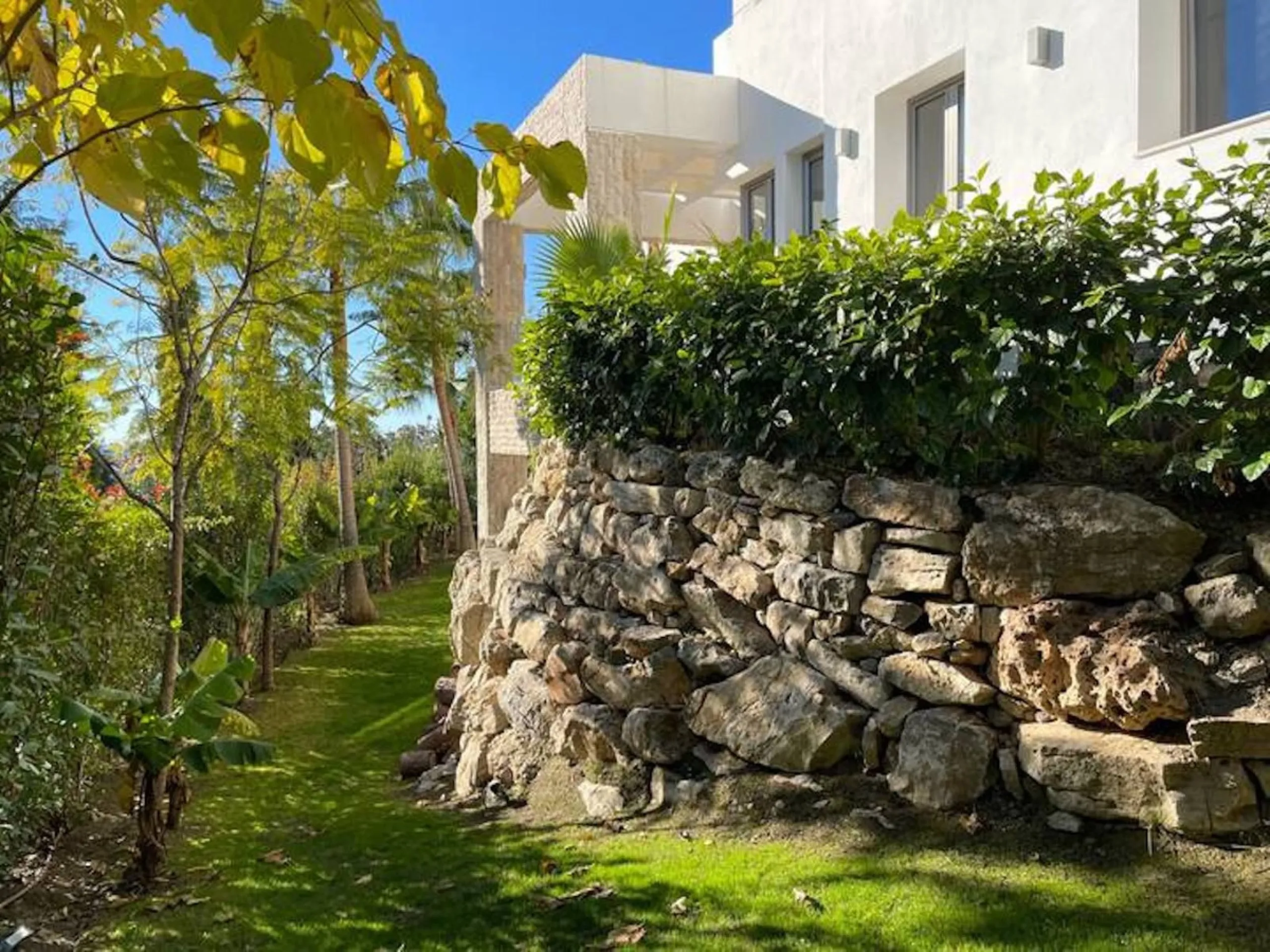 This magnificent villa is an open plan one, and the ground floor flows into the terrace and the garden with lovely sea views and a vast infinity pool, leading to a chill-out area with a fireplace. The villa has ensuite bedrooms on each floor, which gives 