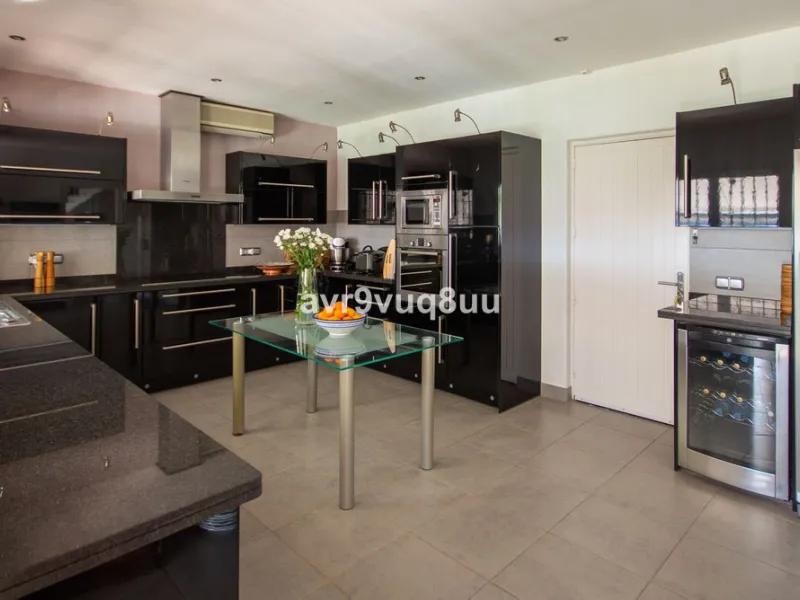 This property is stunning! Set in the heart of Mijas Costa, in the desirable Campo Mijas area. From the private entrance there is a driveway and garage, with steps down into the main entrance. This floor has a very spacious lounge area, with a great recep
