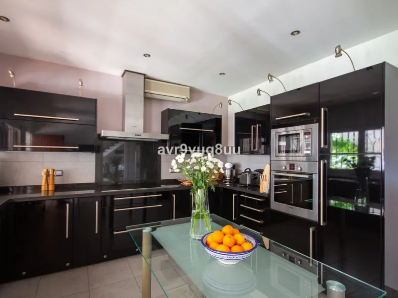 This property is stunning! Set in the heart of Mijas Costa, in the desirable Campo Mijas area. From the private entrance there is a driveway and garage, with steps down into the main entrance. This floor has a very spacious lounge area, with a great recep