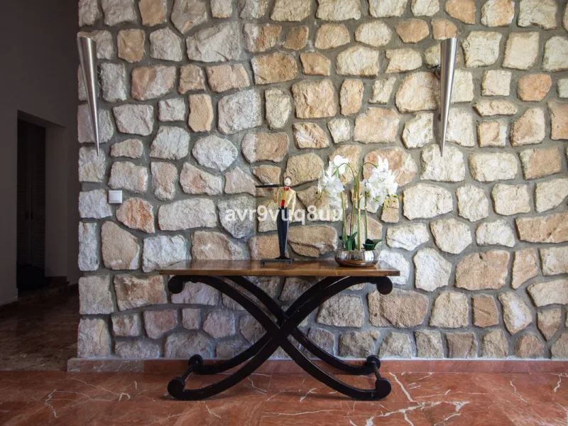 This property is stunning! Set in the heart of Mijas Costa, in the desirable Campo Mijas area. From the private entrance there is a driveway and garage, with steps down into the main entrance. This floor has a very spacious lounge area, with a great recep