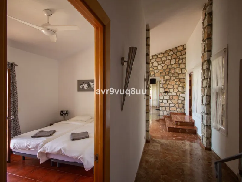 This property is stunning! Set in the heart of Mijas Costa, in the desirable Campo Mijas area. From the private entrance there is a driveway and garage, with steps down into the main entrance. This floor has a very spacious lounge area, with a great recep