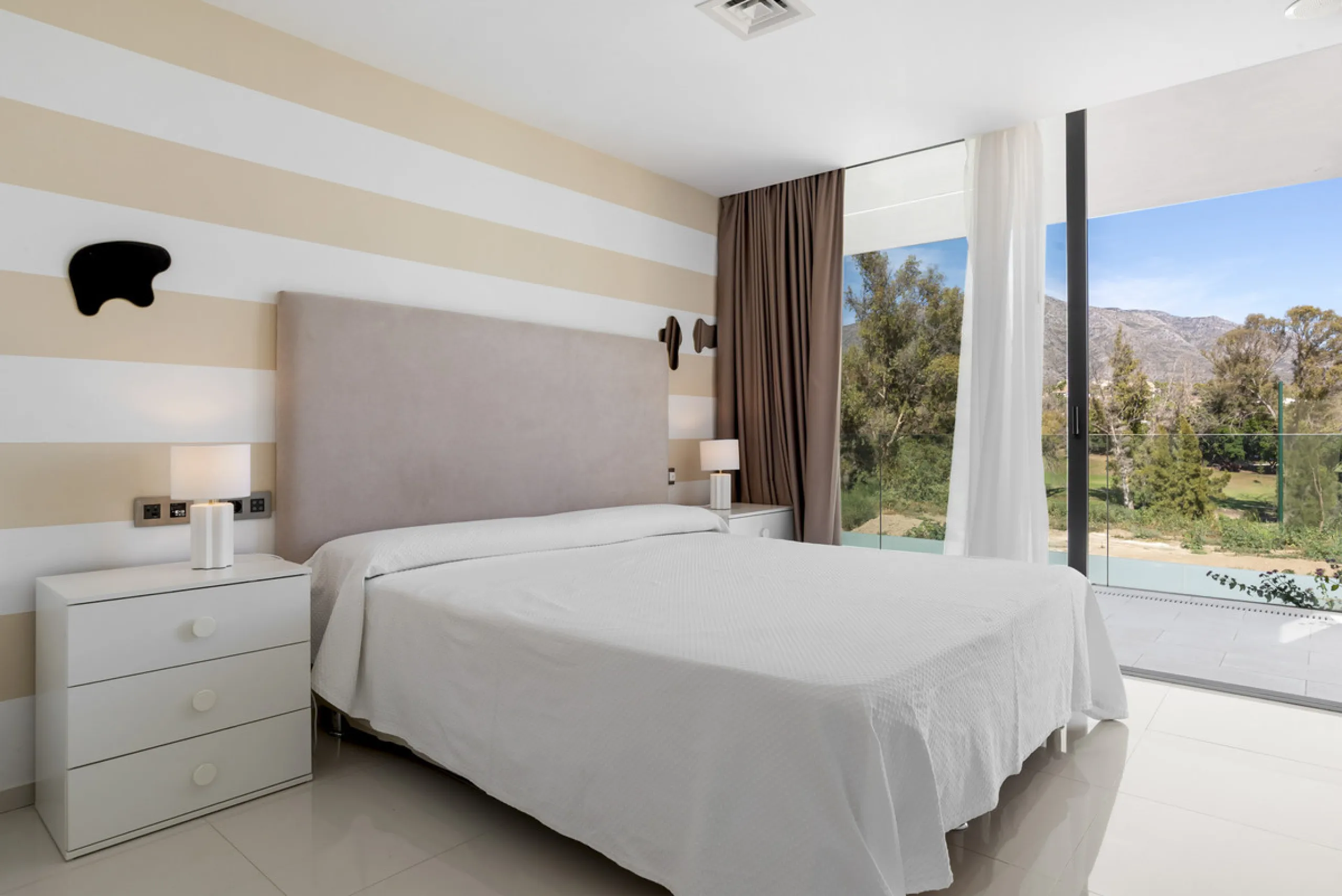 Nestled in the prestigious enclave of La Cerquilla, Villa La Cerquilla is a sanctuary of contemporary luxury surrounded by the beauty of Marbella's Golf Valley. Behind its private gates, the residence opens onto five generous double bedrooms, including a 