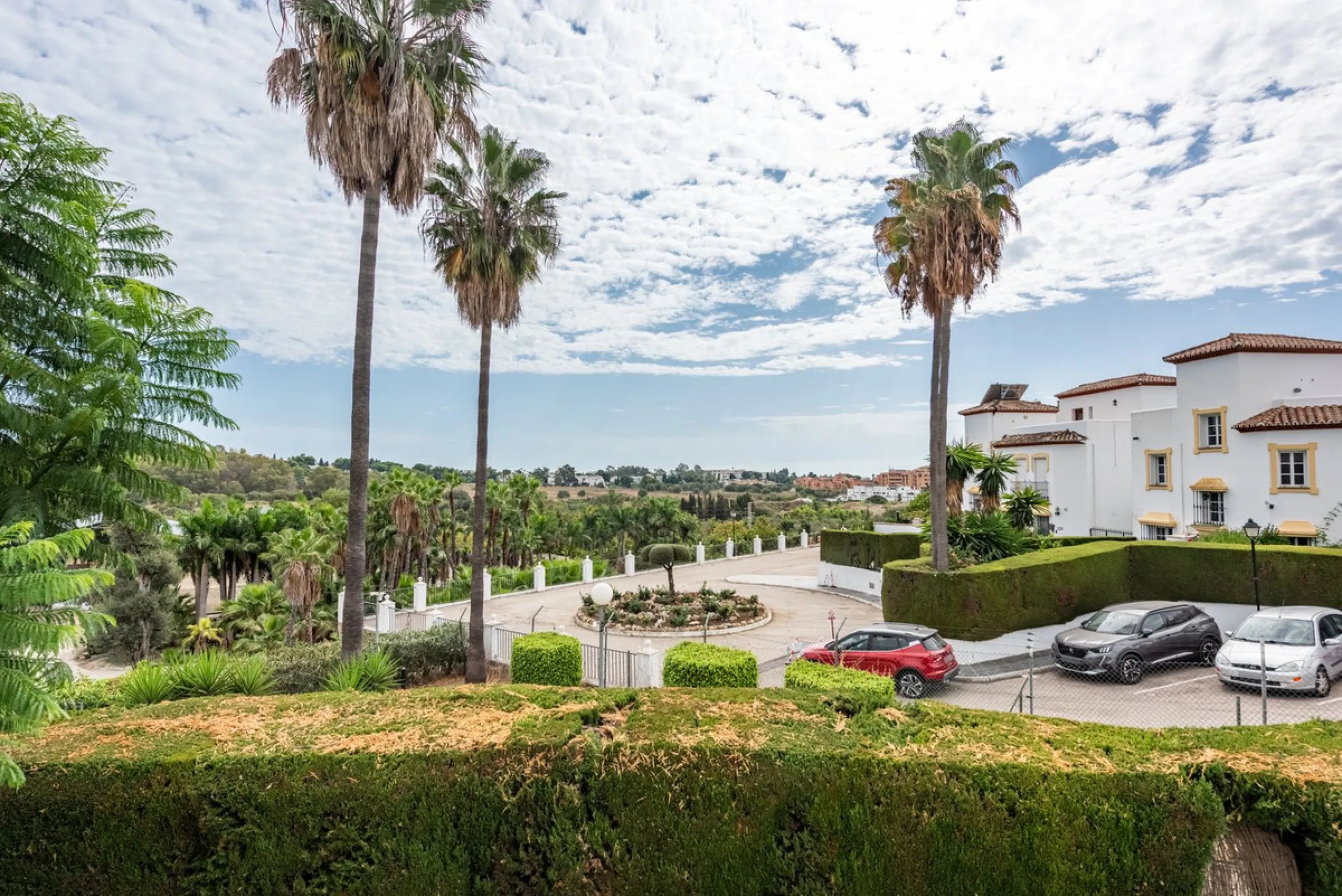 Bright and spacious apartment located in the sought-after Las Jacarandas complex in Bel Air, Estepona. Situated on the first floor, this corner unit enjoys an abundance of natural light and offers tranquil green views with glimpses of the mountains and di