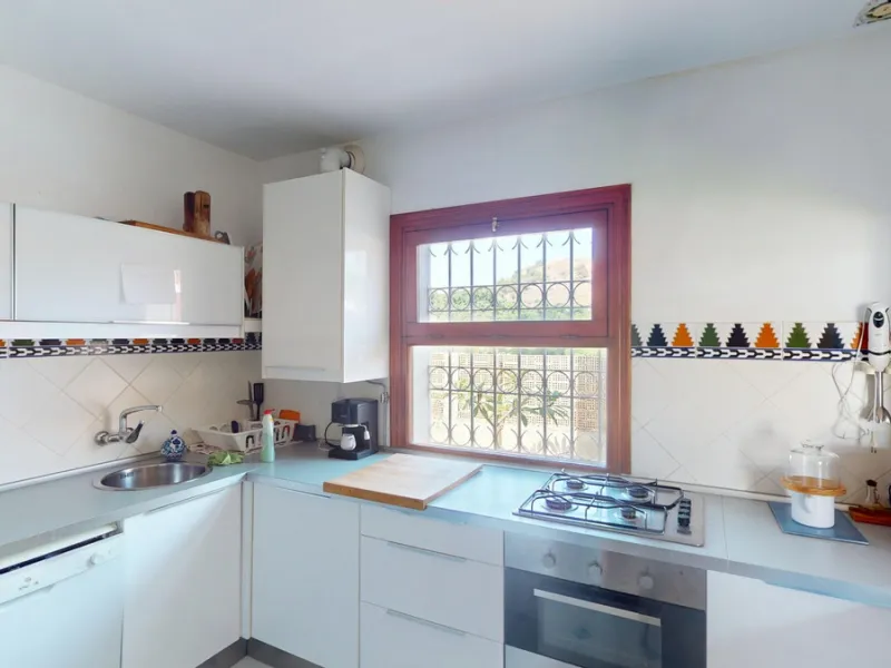 This beautiful Spanish villa spans two floors and features three bedrooms, including an impressive primary suite, and two bathrooms, blending traditional Andalusian charm with modern comfort. The Mediterranean-inspired design is reflected in the terracott