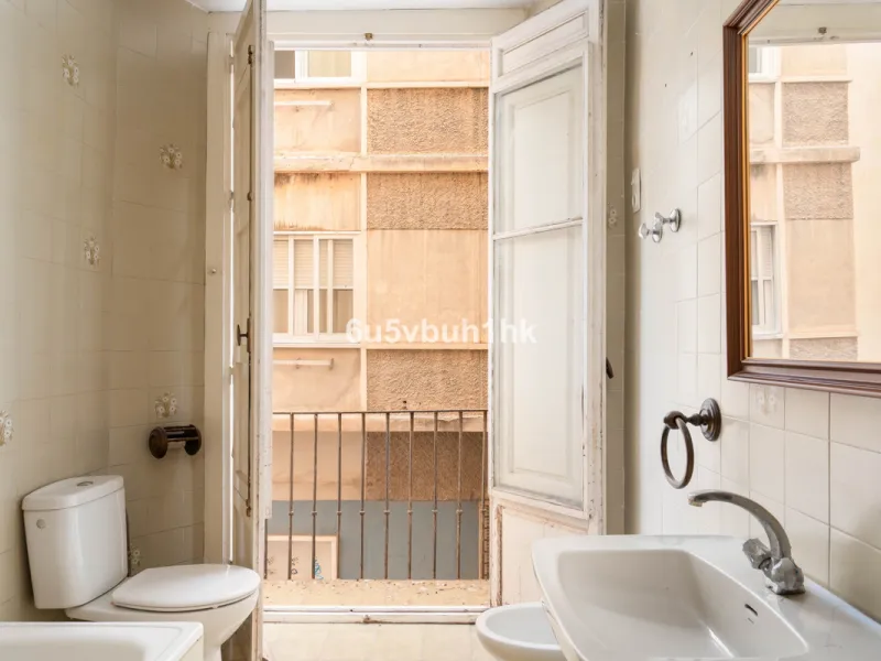 In the very heart of Málaga's historic centre, on the corner of two charming pedestrian streets, lies one of those treasures that makes the hearts of architecture lovers beat faster. This is not a move-in-ready home — it's an invitation to dream, to trans
