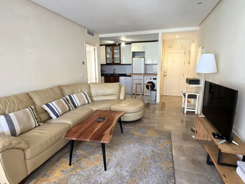 JUST REDUCED .LUXURY GROUND FLOOR GATED COMMUNITY. FRONT LINE GOLF. 2 BED 2 BATH APARTMENT MIRAFLORES. € 299,950 WITH EXISTING TOURIST LICENCE.
