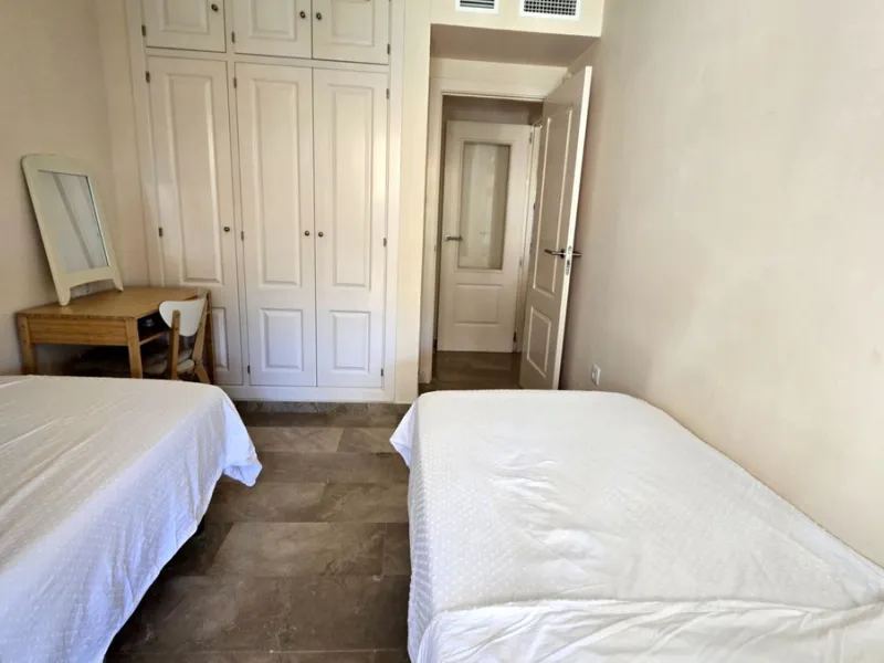 JUST REDUCED .LUXURY GROUND FLOOR GATED COMMUNITY. FRONT LINE GOLF. 2 BED 2 BATH APARTMENT MIRAFLORES. € 299,950 WITH EXISTING TOURIST LICENCE.