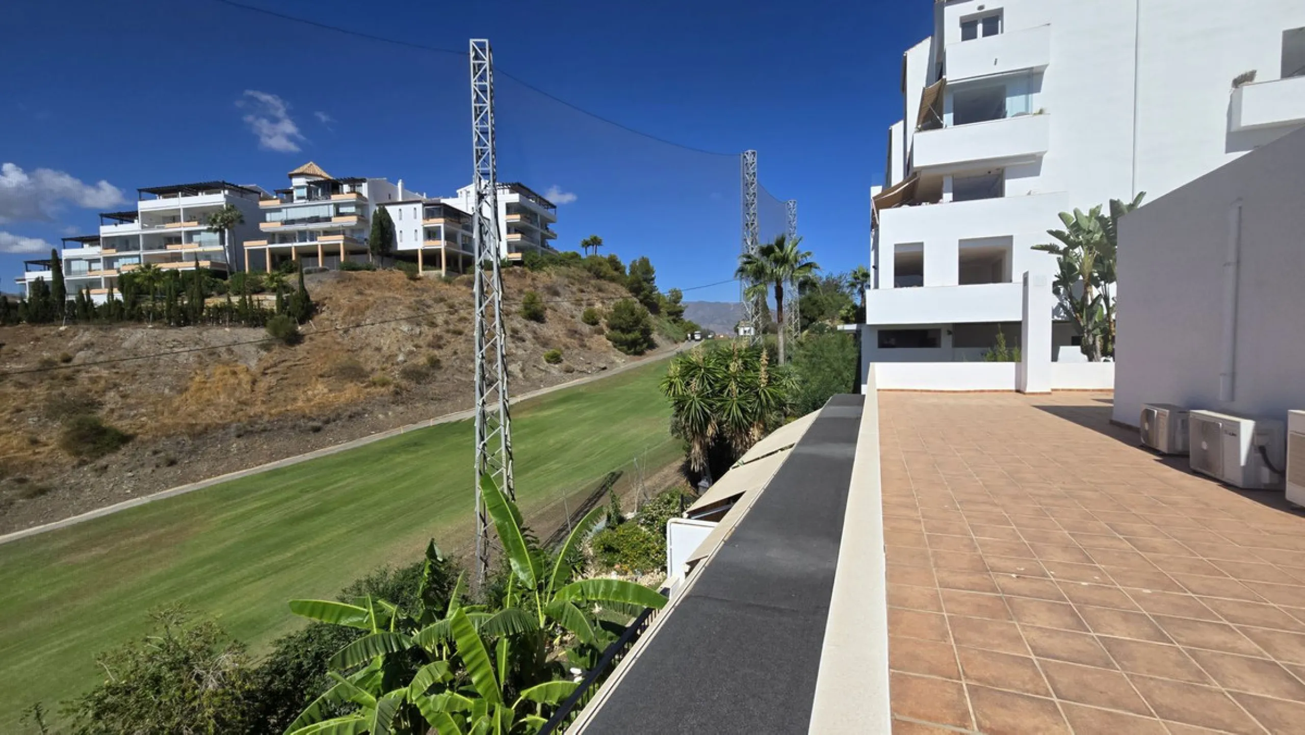 JUST REDUCED .LUXURY GROUND FLOOR GATED COMMUNITY. FRONT LINE GOLF. 2 BED 2 BATH APARTMENT MIRAFLORES. € 299,950 WITH EXISTING TOURIST LICENCE.