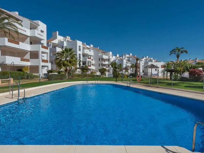 JUST REDUCED .LUXURY GROUND FLOOR GATED COMMUNITY. FRONT LINE GOLF. 2 BED 2 BATH APARTMENT MIRAFLORES. € 299,950 WITH EXISTING TOURIST LICENCE.