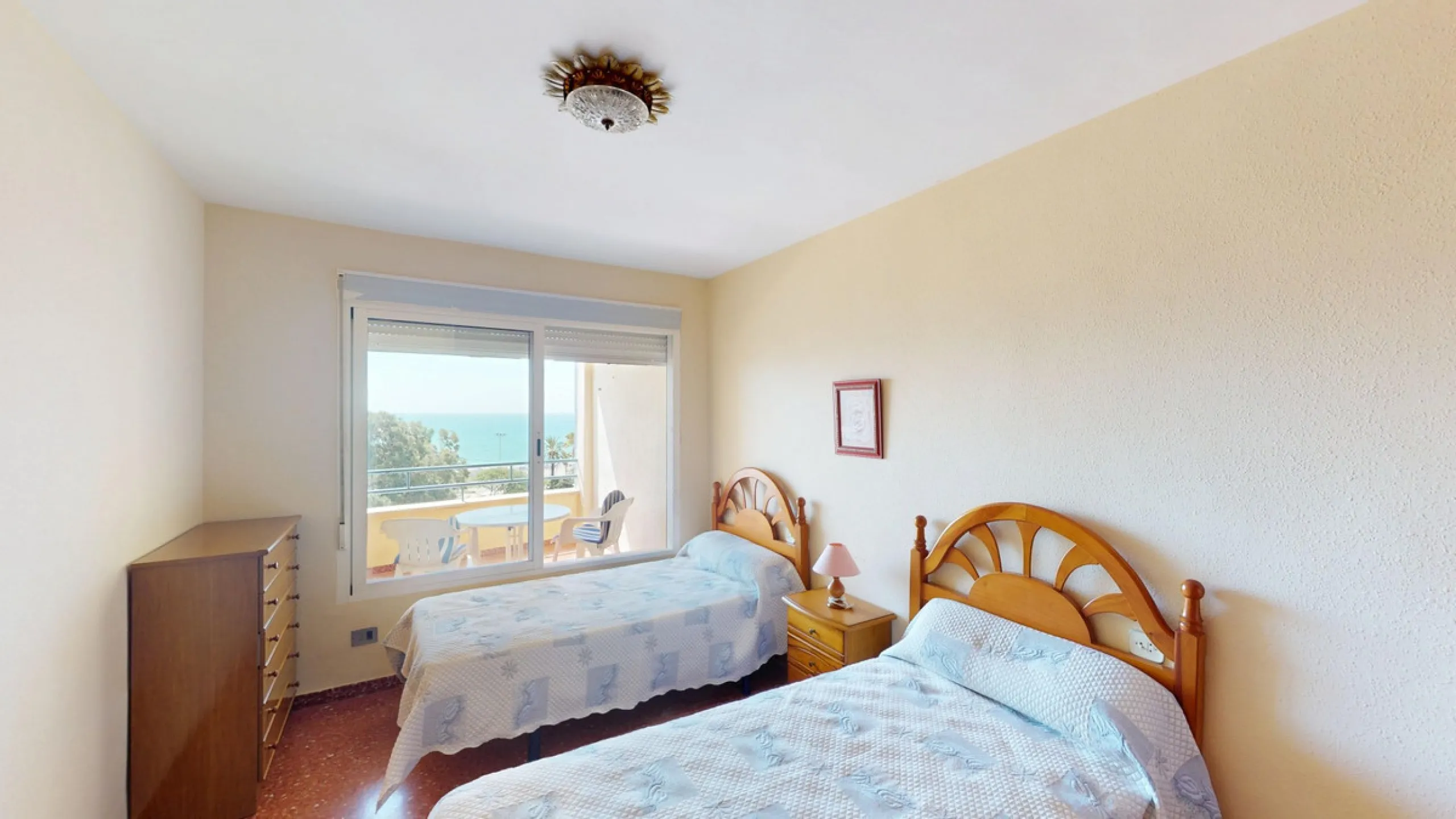 Discover this exceptional 3-bedroom apartment located on one of Torre del Mars main streets, just steps from the beach. This frontline property offers stunning panoramic sea views from all three bedrooms, with two featuring built-in wardrobes for added co
