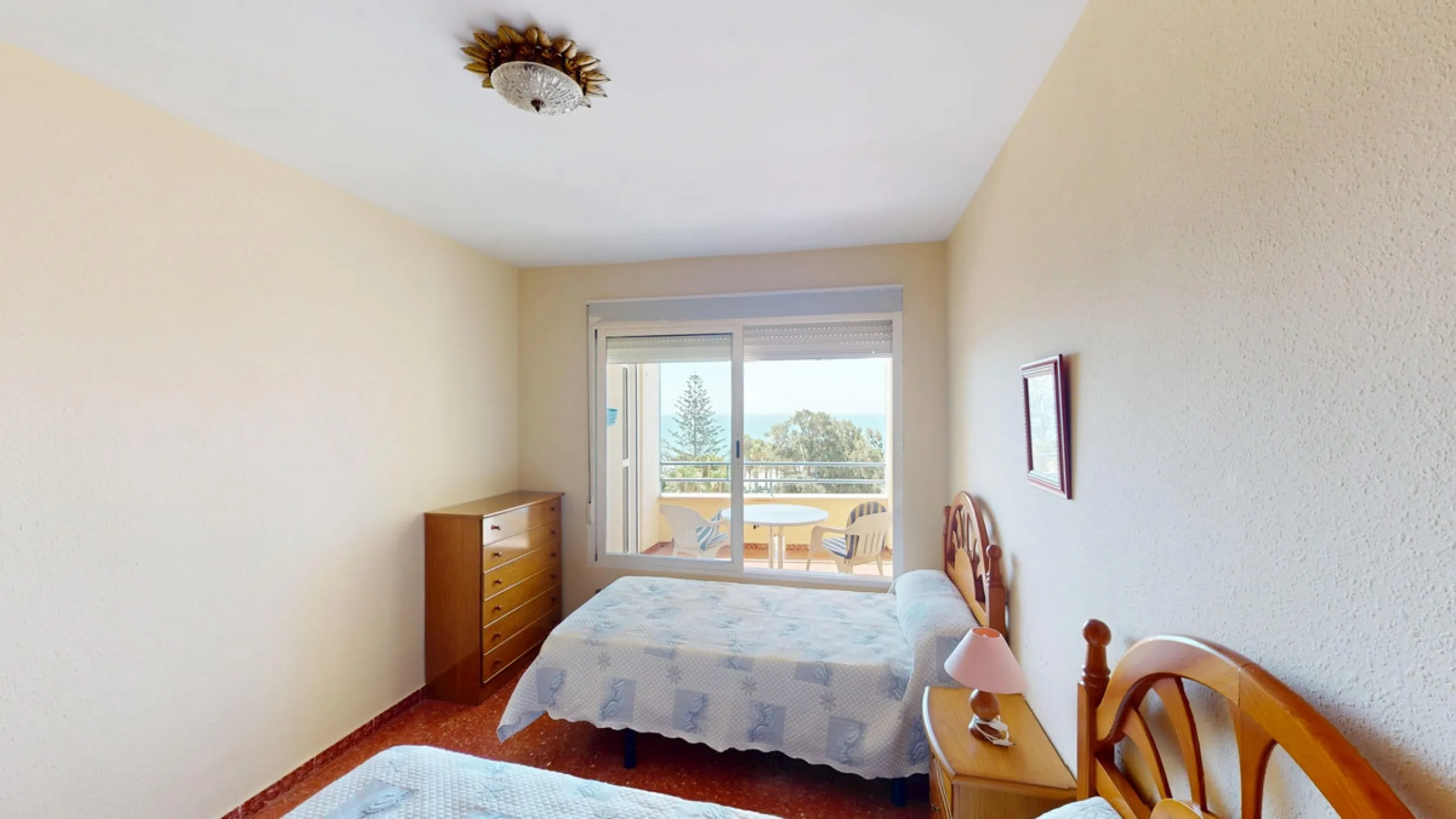 Discover this exceptional 3-bedroom apartment located on one of Torre del Mars main streets, just steps from the beach. This frontline property offers stunning panoramic sea views from all three bedrooms, with two featuring built-in wardrobes for added co