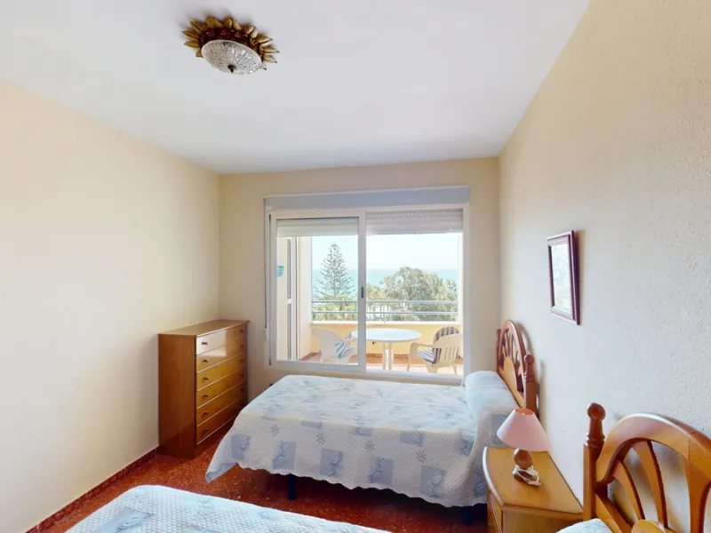 Discover this exceptional 3-bedroom apartment located on one of Torre del Mars main streets, just steps from the beach. This frontline property offers stunning panoramic sea views from all three bedrooms, with two featuring built-in wardrobes for added co