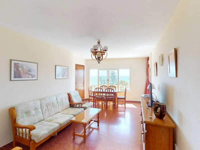 Discover this exceptional 3-bedroom apartment located on one of Torre del Mars main streets, just steps from the beach. This frontline property offers stunning panoramic sea views from all three bedrooms, with two featuring built-in wardrobes for added co