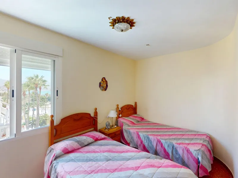 Discover this exceptional 3-bedroom apartment located on one of Torre del Mars main streets, just steps from the beach. This frontline property offers stunning panoramic sea views from all three bedrooms, with two featuring built-in wardrobes for added co