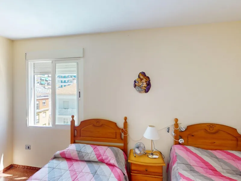 Discover this exceptional 3-bedroom apartment located on one of Torre del Mars main streets, just steps from the beach. This frontline property offers stunning panoramic sea views from all three bedrooms, with two featuring built-in wardrobes for added co