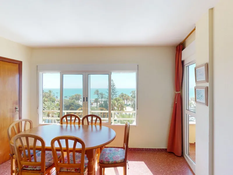 Discover this exceptional 3-bedroom apartment located on one of Torre del Mars main streets, just steps from the beach. This frontline property offers stunning panoramic sea views from all three bedrooms, with two featuring built-in wardrobes for added co