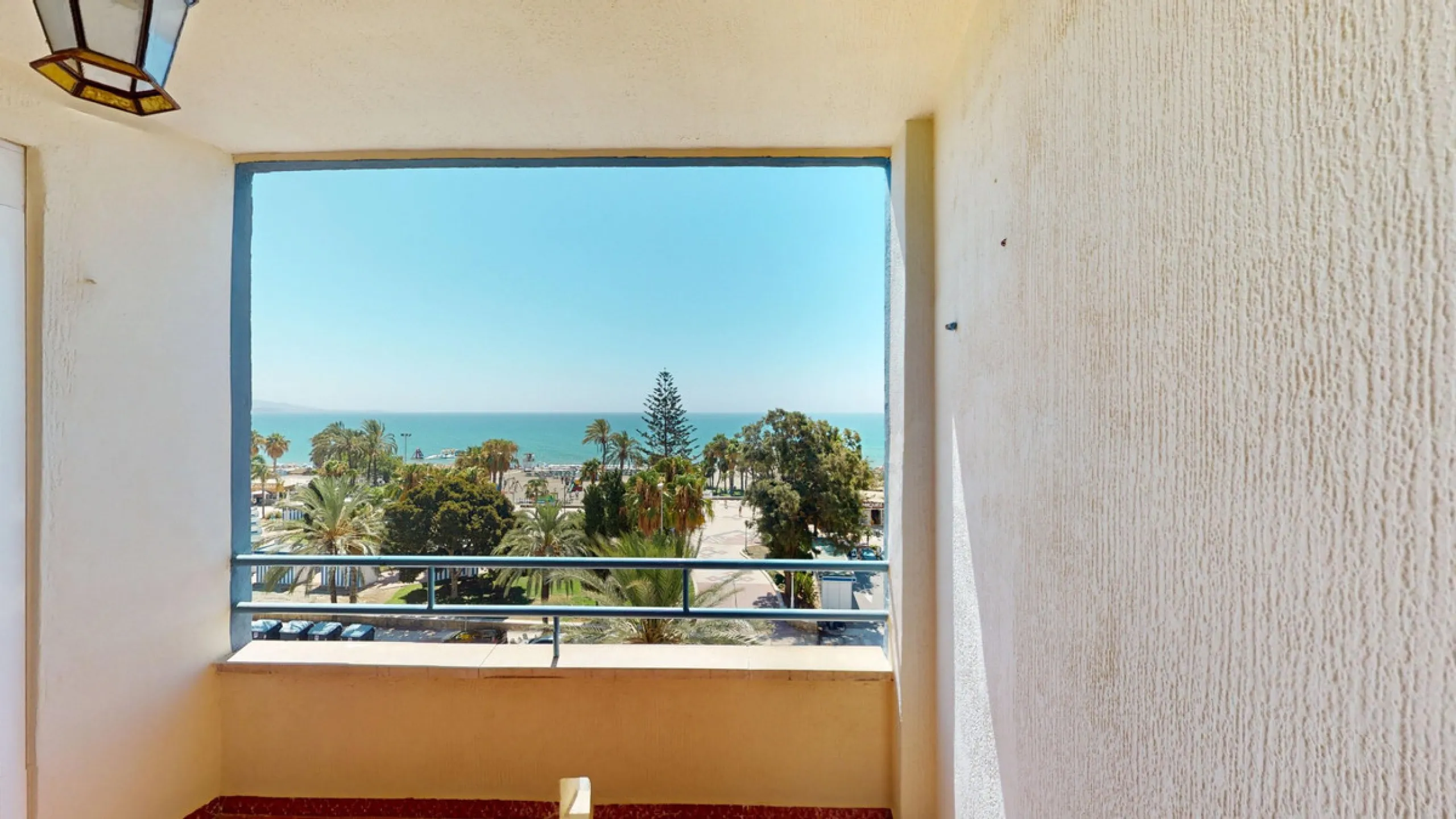 Discover this exceptional 3-bedroom apartment located on one of Torre del Mars main streets, just steps from the beach. This frontline property offers stunning panoramic sea views from all three bedrooms, with two featuring built-in wardrobes for added co