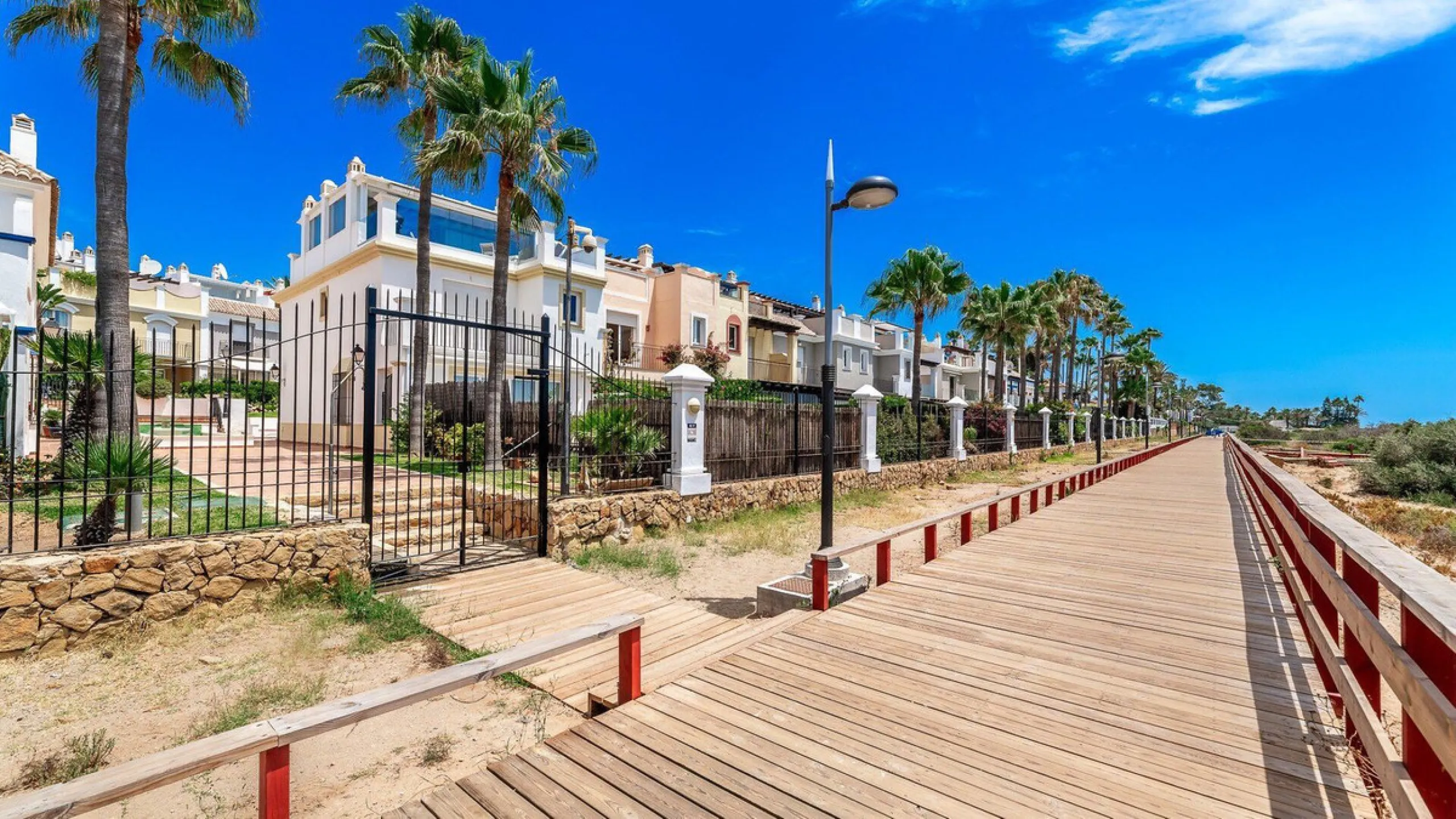 Nestled within one of Bahía de Marbella's most sought-after beachfront urbanizations, this stunning townhouse offers an unparalleled coastal living experience. Imagine waking up to the sound of the waves and having direct, private access to the golden san