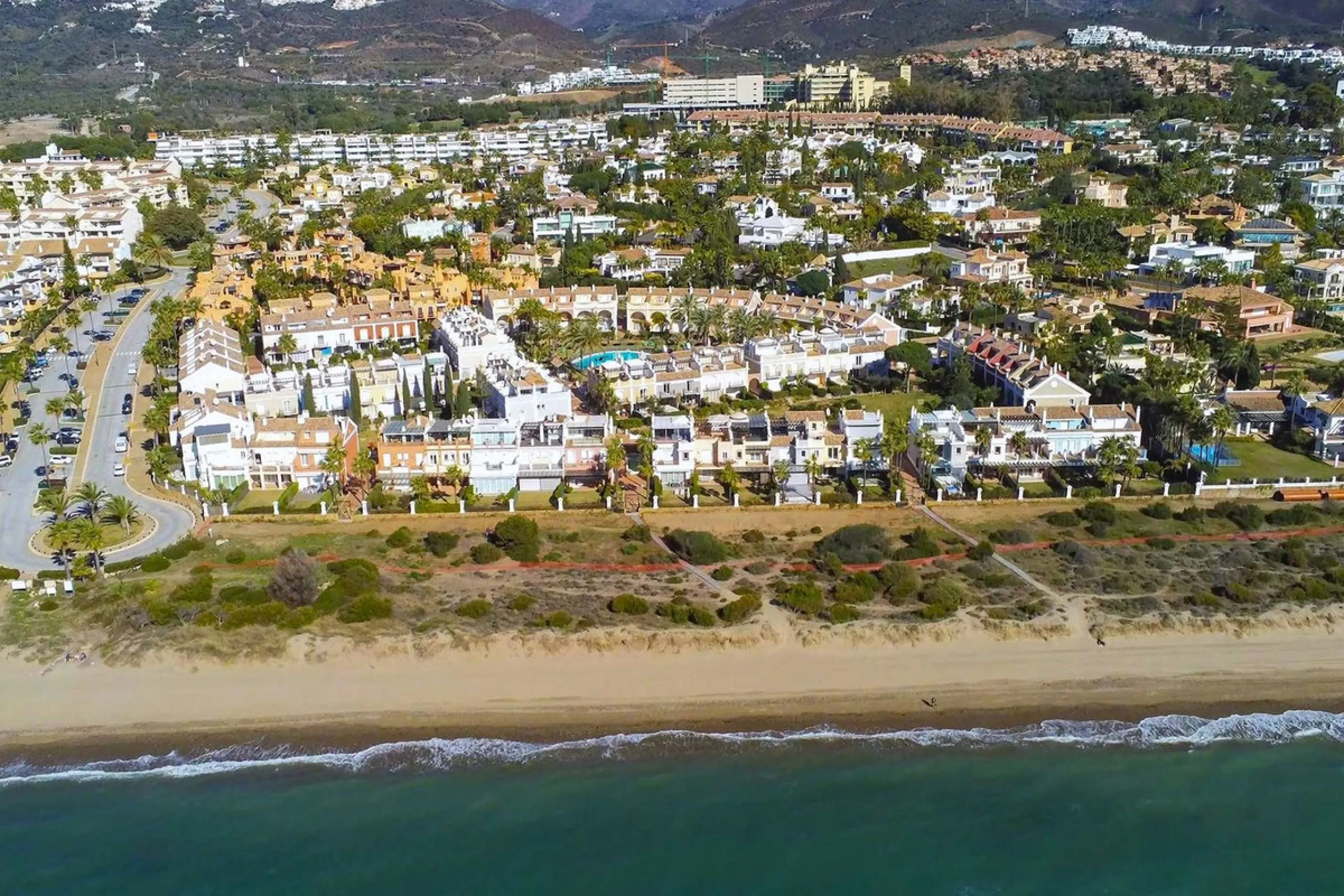 Nestled within one of Bahía de Marbella's most sought-after beachfront urbanizations, this stunning townhouse offers an unparalleled coastal living experience. Imagine waking up to the sound of the waves and having direct, private access to the golden san