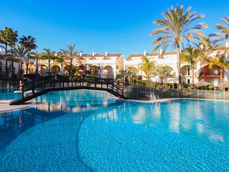 Nestled within one of Bahía de Marbella's most sought-after beachfront urbanizations, this stunning townhouse offers an unparalleled coastal living experience. Imagine waking up to the sound of the waves and having direct, private access to the golden san