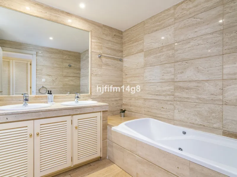 Discover this elegant two-bedroom elevated ground floor apartment for sale in the sought-after Albatross Hill complex, nestled in the scenic hills of Nueva Andalucía. This exclusive gated community offers a peaceful, secure lifestyle with outstanding amen