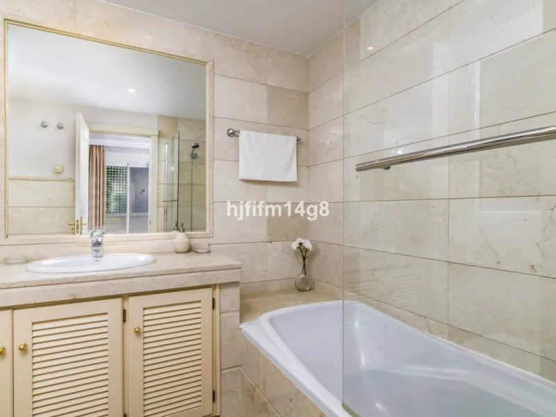 Discover this elegant two-bedroom elevated ground floor apartment for sale in the sought-after Albatross Hill complex, nestled in the scenic hills of Nueva Andalucía. This exclusive gated community offers a peaceful, secure lifestyle with outstanding amen