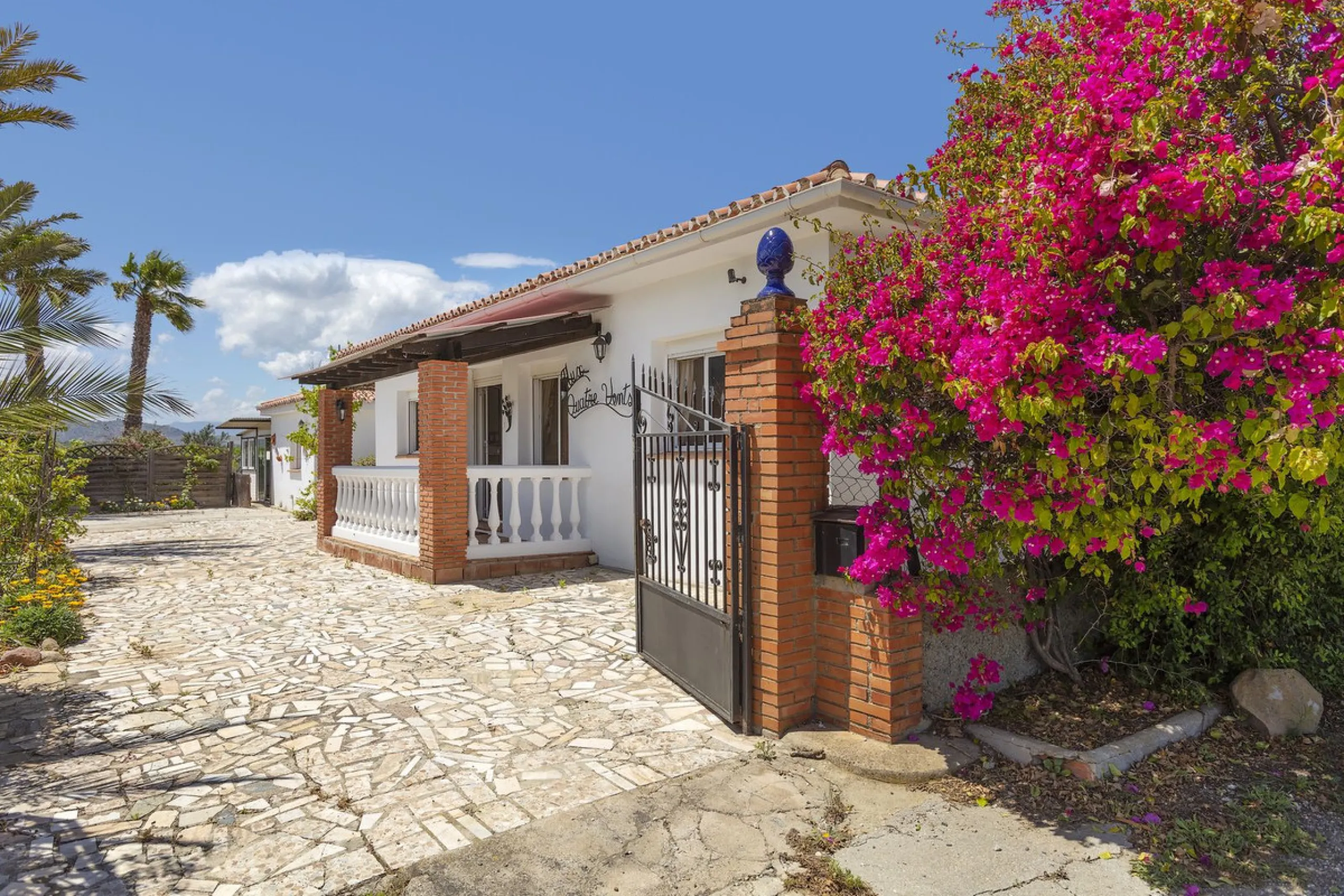 This finca set in an elevated position has impressive mountain views all around it.  The garden is split into different areas each with its own beautiful vibe. Stylish barbecue area by the pool is great for relaxing and welcoming guests.  Main house has t