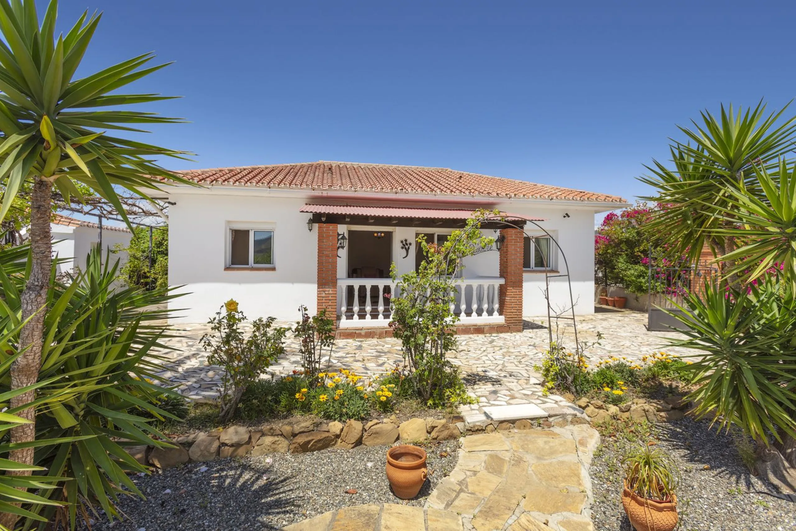 This finca set in an elevated position has impressive mountain views all around it.  The garden is split into different areas each with its own beautiful vibe. Stylish barbecue area by the pool is great for relaxing and welcoming guests.  Main house has t