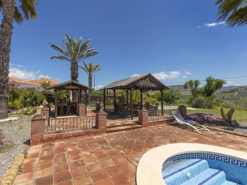 This finca set in an elevated position has impressive mountain views all around it.  The garden is split into different areas each with its own beautiful vibe. Stylish barbecue area by the pool is great for relaxing and welcoming guests.  Main house has t