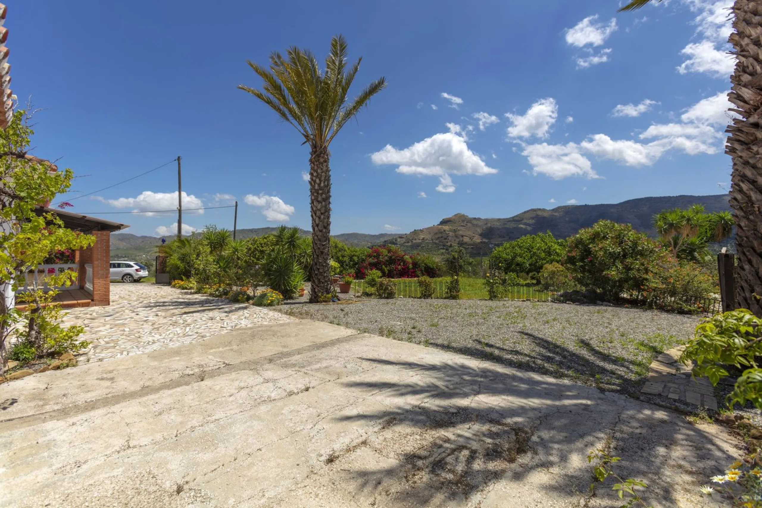 This finca set in an elevated position has impressive mountain views all around it.  The garden is split into different areas each with its own beautiful vibe. Stylish barbecue area by the pool is great for relaxing and welcoming guests.  Main house has t