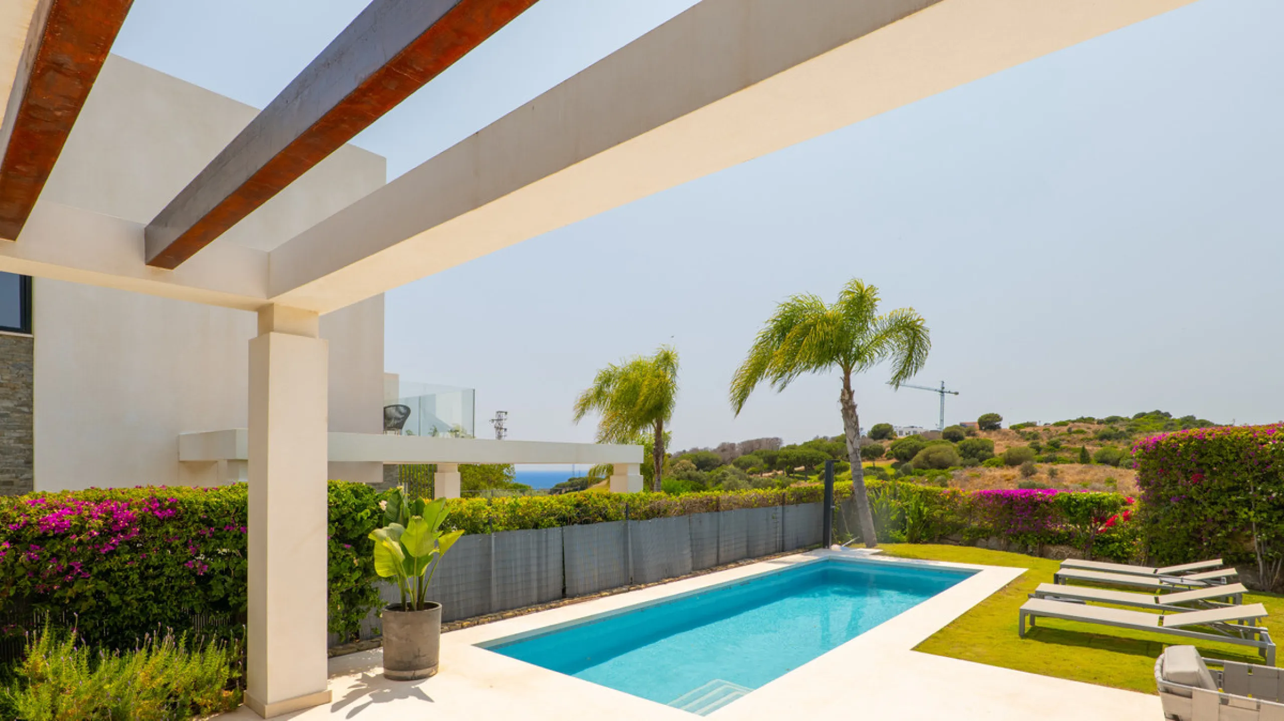 This stunning semi-detached villa offers panoramic views of the Mediterranean Sea and the lush Cabopino Golf Course, set within the exclusive gated community of Green Hill Marbella. Surrounded by rolling Andalusian hills, the home blends sleek modern desi