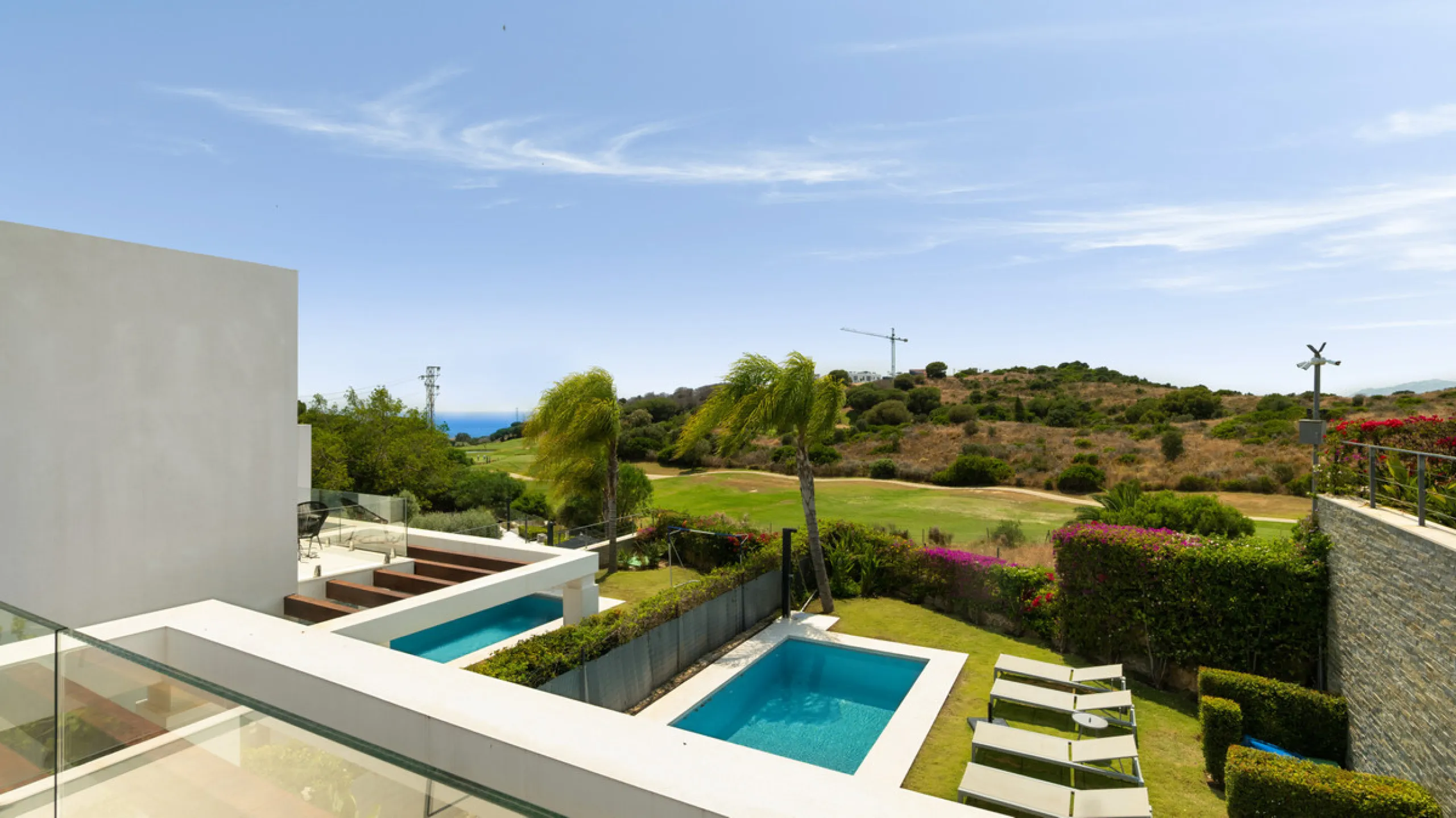 This stunning semi-detached villa offers panoramic views of the Mediterranean Sea and the lush Cabopino Golf Course, set within the exclusive gated community of Green Hill Marbella. Surrounded by rolling Andalusian hills, the home blends sleek modern desi