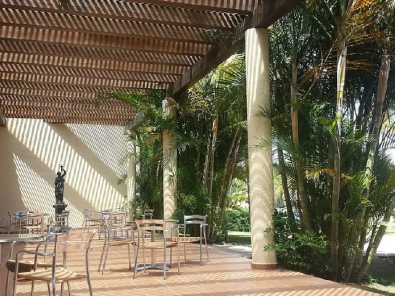 Welcome to this stunning 2-bedroom, 2-bathroom apartment, perfectly situated in a gated community that offers both comfort and convenience. As you step inside, a small hallway leads you to a spacious open-plan living room that connects to a grand solarium