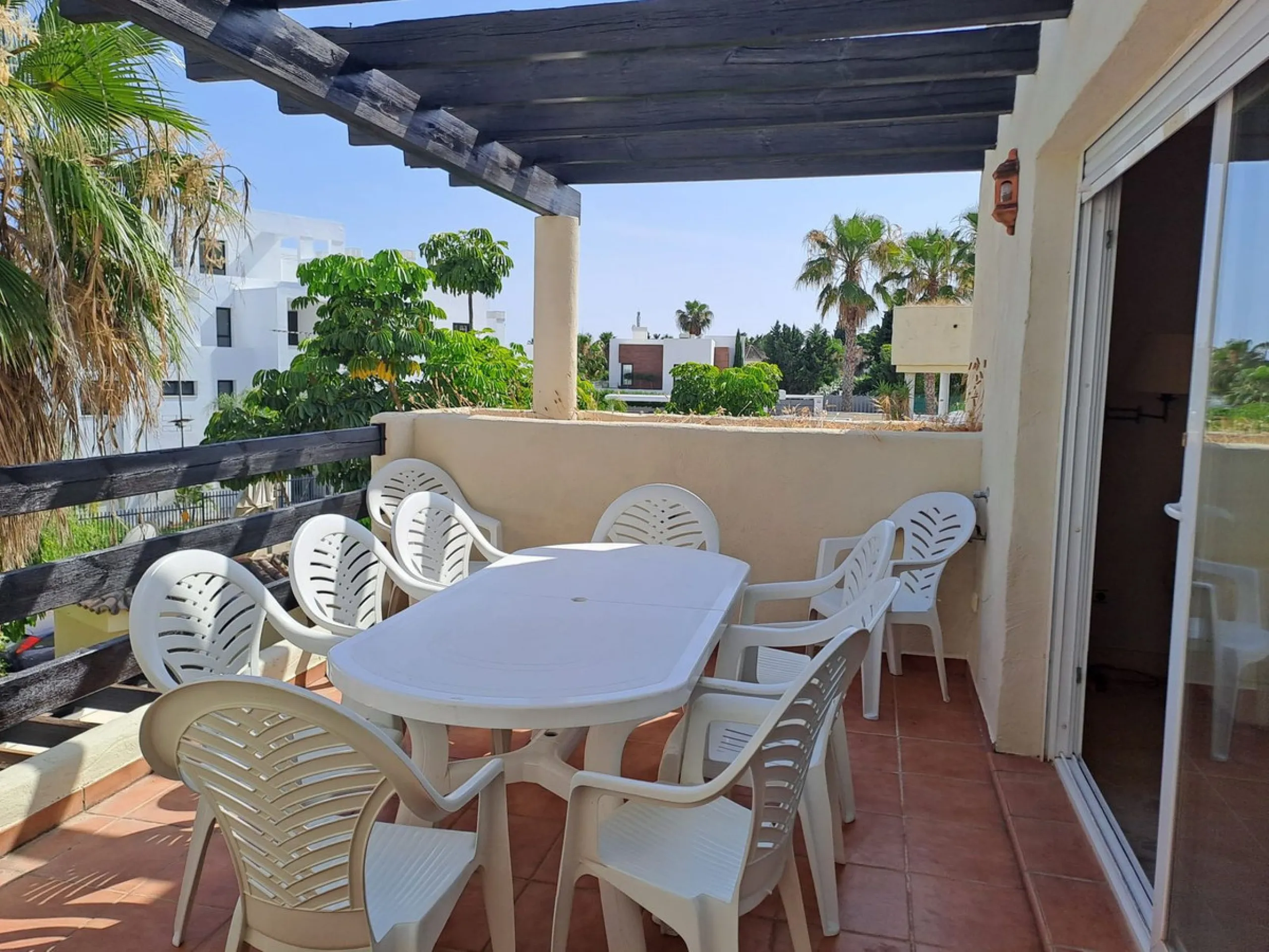Welcome to this stunning 2-bedroom, 2-bathroom apartment, perfectly situated in a gated community that offers both comfort and convenience. As you step inside, a small hallway leads you to a spacious open-plan living room that connects to a grand solarium