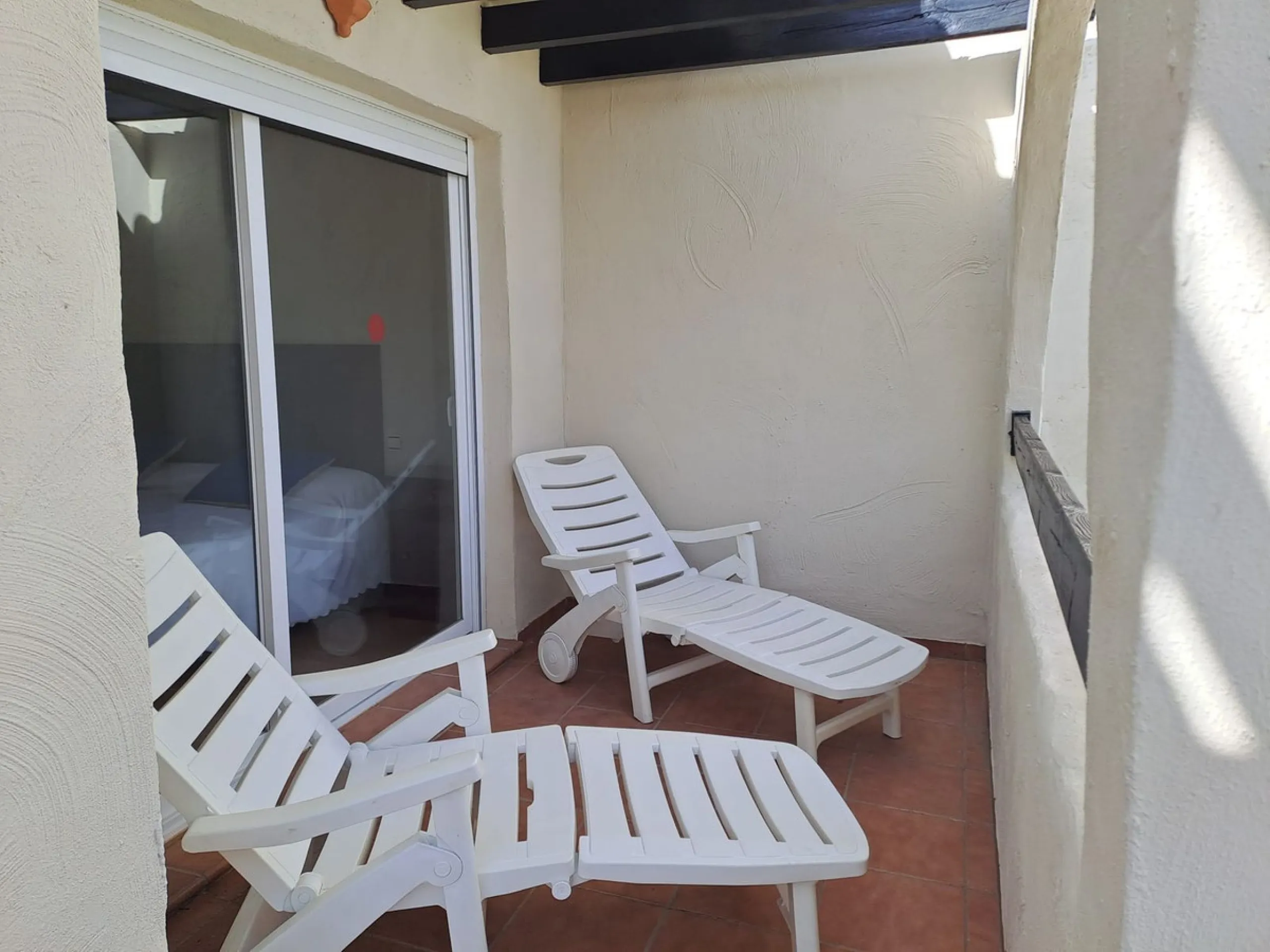 Welcome to this stunning 2-bedroom, 2-bathroom apartment, perfectly situated in a gated community that offers both comfort and convenience. As you step inside, a small hallway leads you to a spacious open-plan living room that connects to a grand solarium