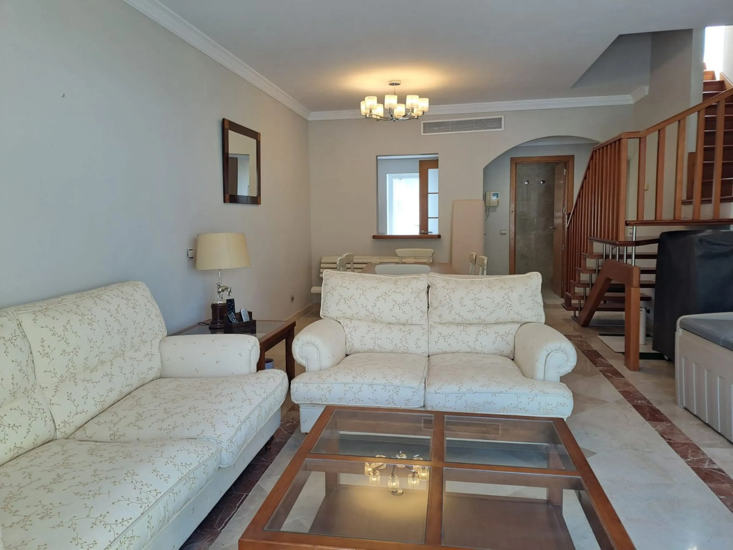 Welcome to this stunning 2-bedroom, 2-bathroom apartment, perfectly situated in a gated community that offers both comfort and convenience. As you step inside, a small hallway leads you to a spacious open-plan living room that connects to a grand solarium