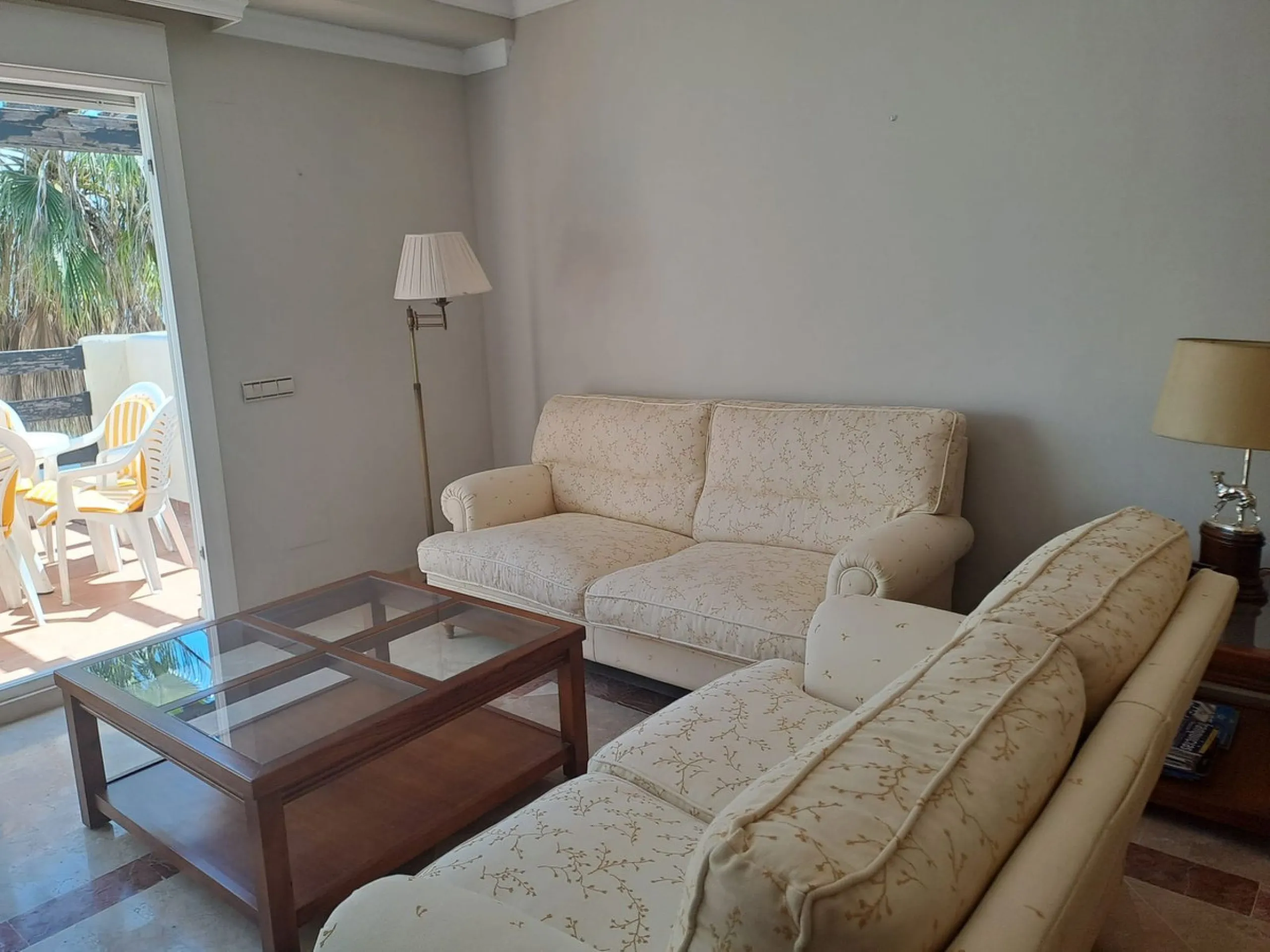 Welcome to this stunning 2-bedroom, 2-bathroom apartment, perfectly situated in a gated community that offers both comfort and convenience. As you step inside, a small hallway leads you to a spacious open-plan living room that connects to a grand solarium
