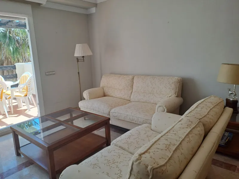 Welcome to this stunning 2-bedroom, 2-bathroom apartment, perfectly situated in a gated community that offers both comfort and convenience. As you step inside, a small hallway leads you to a spacious open-plan living room that connects to a grand solarium
