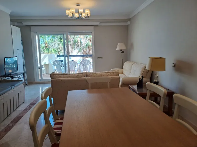 Welcome to this stunning 2-bedroom, 2-bathroom apartment, perfectly situated in a gated community that offers both comfort and convenience. As you step inside, a small hallway leads you to a spacious open-plan living room that connects to a grand solarium